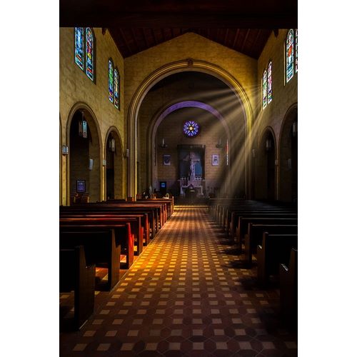 Golden light of sunrays coming into the stained glass windows of St Leos Abbey in Florida